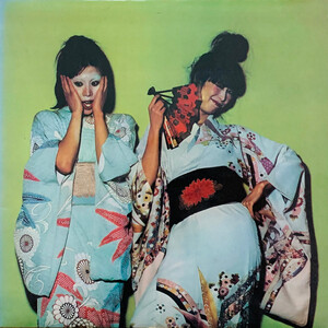 The sleeve of Kimono My House by Sparks, two women in traditional Japanese kimono, one looking shocked with her hands to her face, and the other holding a fan and winking. The man with the small moustache is nowhere to be seen.